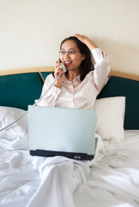 Woman on the phone in her hotel room